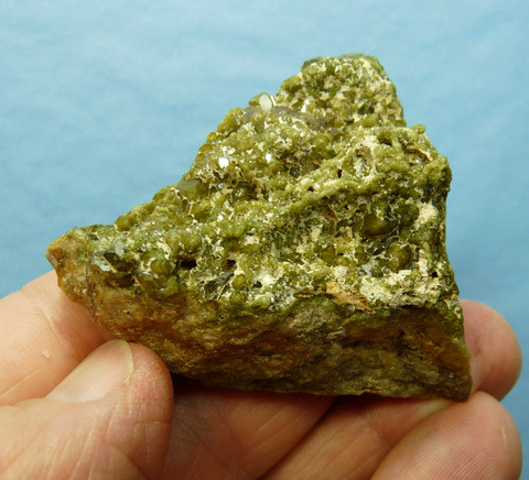 Olive green demantoid garnets on a conglomorate matrix Olive green demantoid garnets on a conglomorate matrix