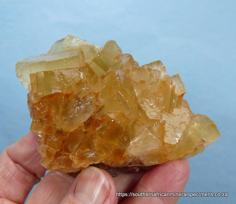 Plate of yellowish to orangy coloured fluorite crystals that displays well