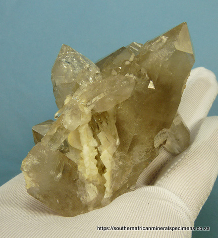 Light smoky quartz crystal group with rutile and feldspar Light smoky quartz crystal group with rutile and feldspar